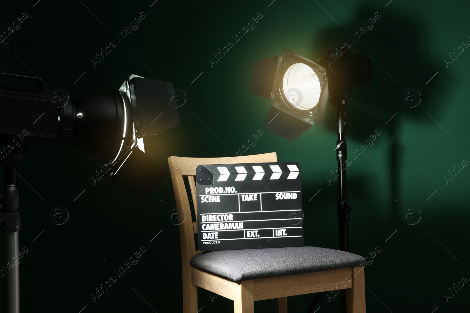 Photo of Chair with clapperboard under spotlight in studio