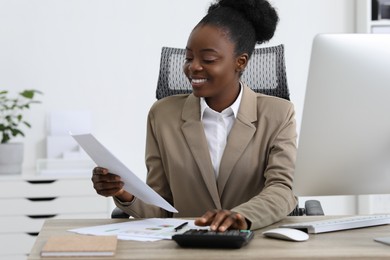 Professional accountant working at wooden desk in office