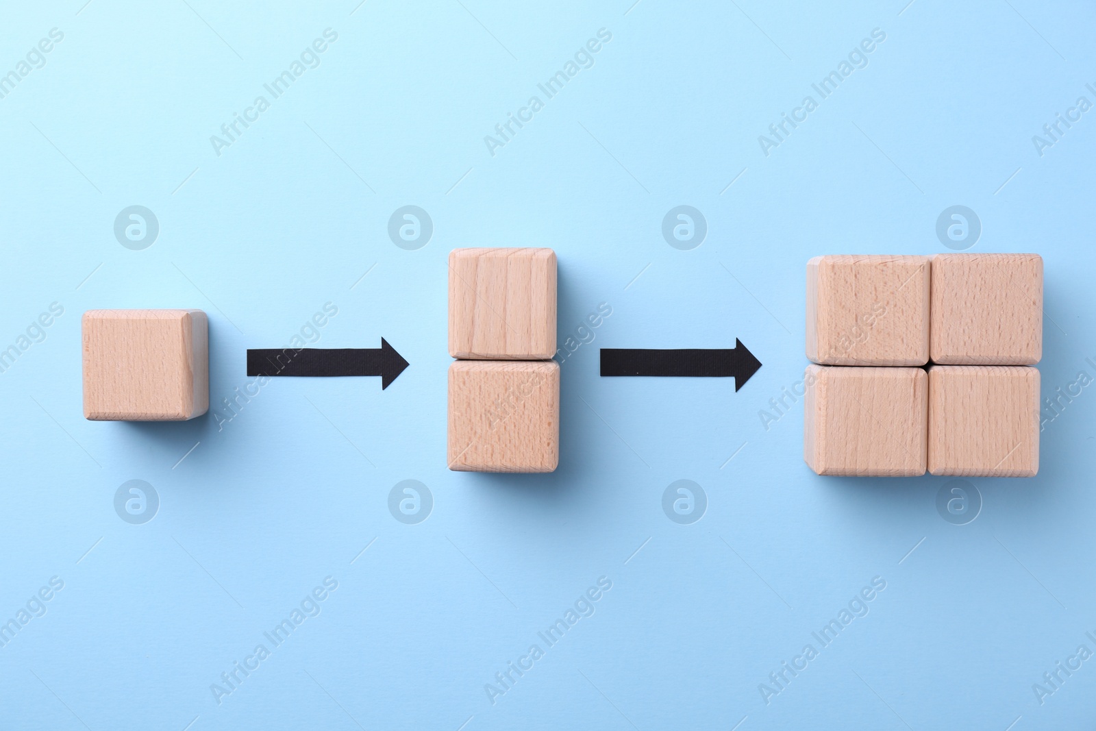 Photo of Business process organization and optimization. Scheme with wooden figures and arrows on light blue background, top view