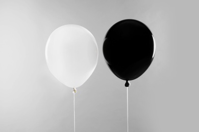 Photo of Color balloons for Halloween party on light grey background
