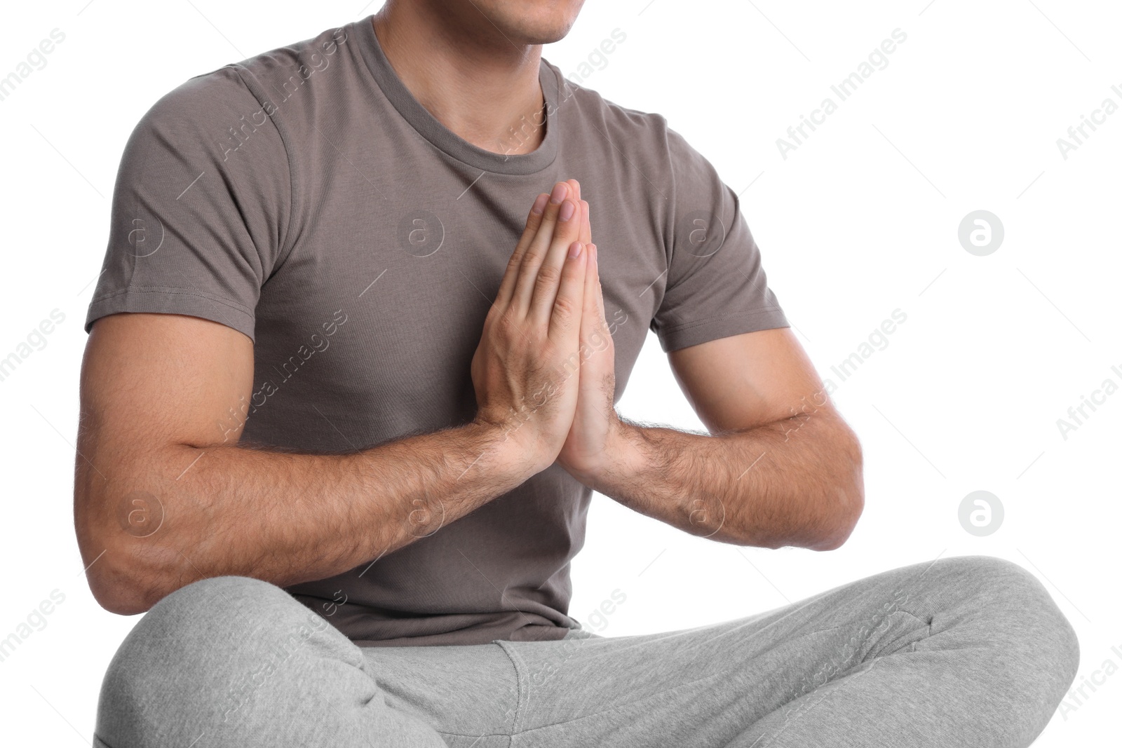 Photo of Man meditating on white background, closeup. Harmony and zen