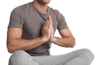 Photo of Man meditating on white background, closeup. Harmony and zen