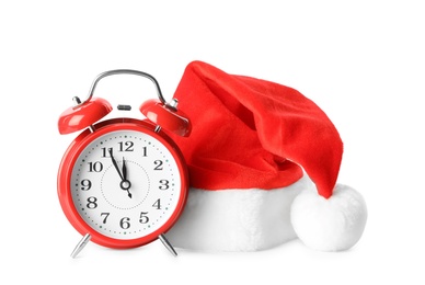 Photo of Alarm clock and Santa hat on white background. New Year countdown