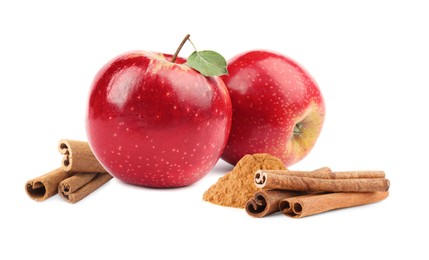 Aromatic cinnamon sticks, powder and red apples isolated on white