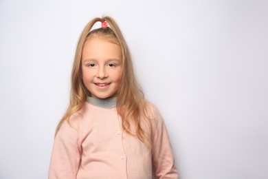 Photo of Happy little girl on white background. Space for text