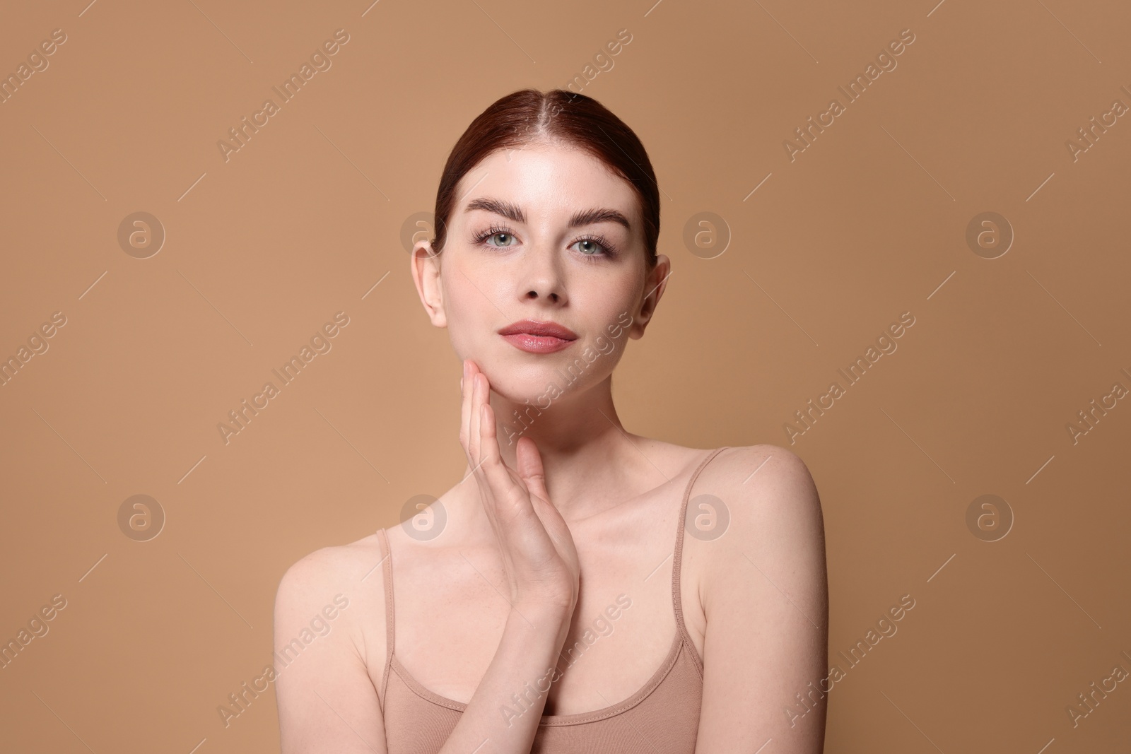 Photo of Portrait of beautiful woman on beige background