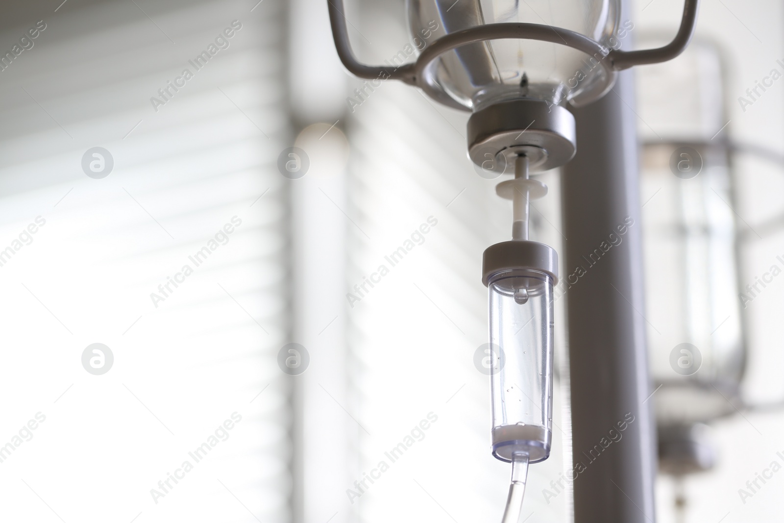 Photo of IV drip against blurred background, space for text