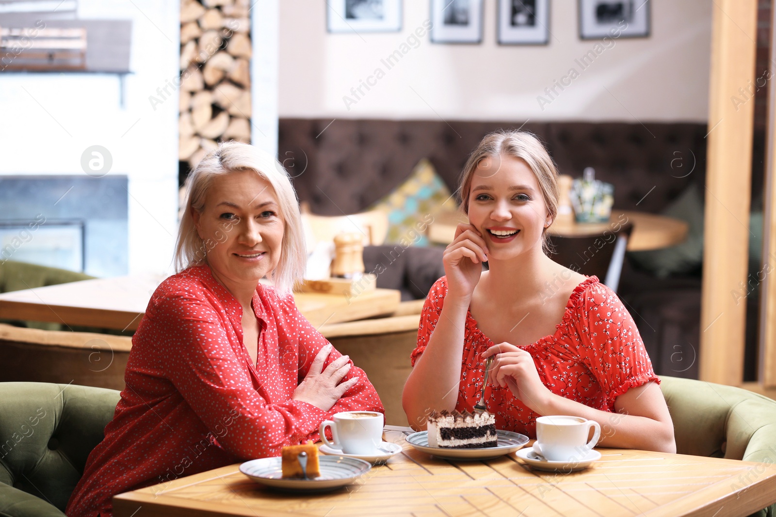 Photo of Mother and her adult daughter spending time together in cafe