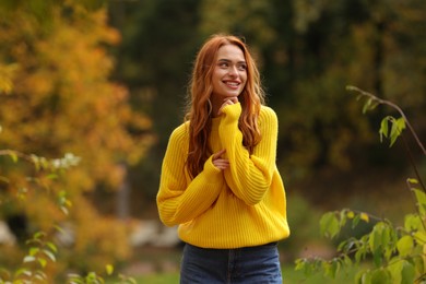 Portrait of happy woman in autumn park