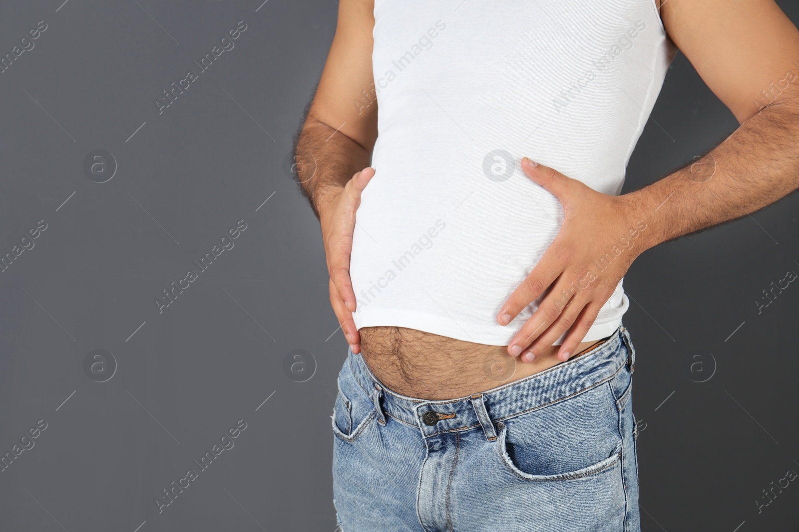 Photo of Overweight man on gray background, closeup view