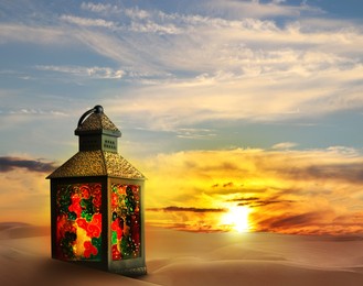 Image of Beautiful Arabic lantern on sand at sunrise, space for text