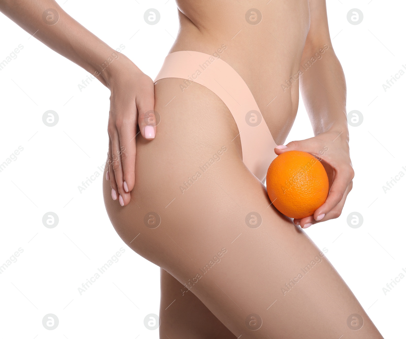 Photo of Closeup view of slim woman in underwear with orange on white background. Cellulite problem concept