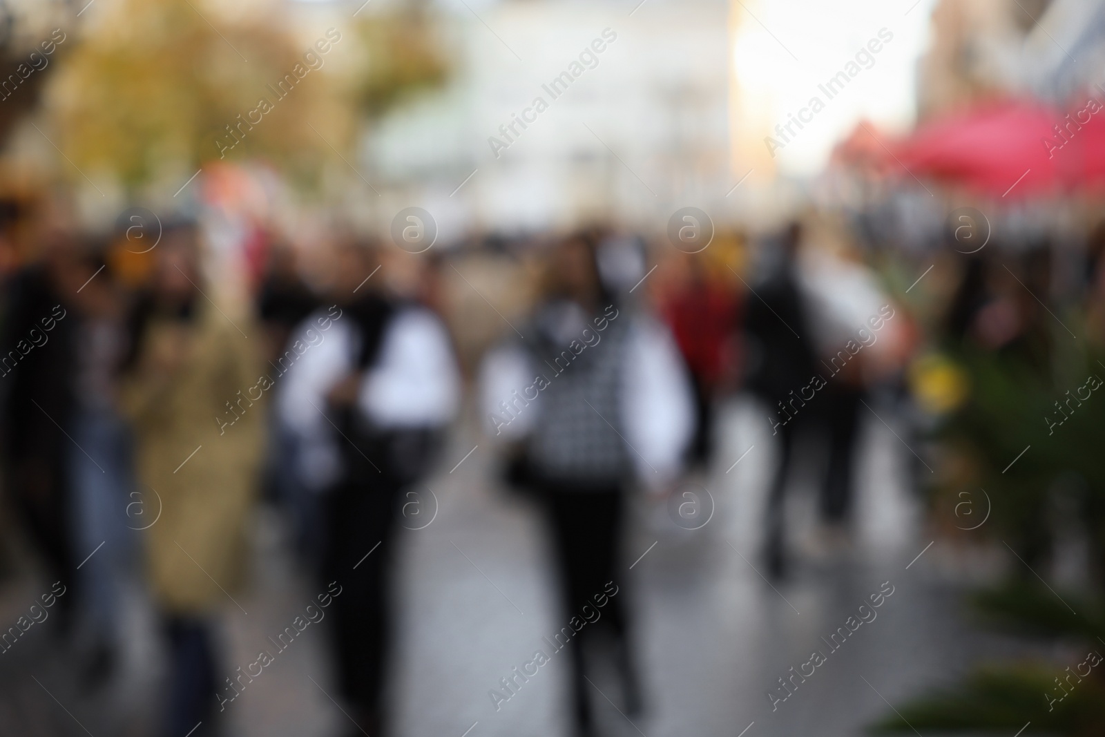 Photo of Blurred view of people walking on city street