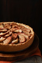 Photo of Delicious apple pie on wooden table, closeup