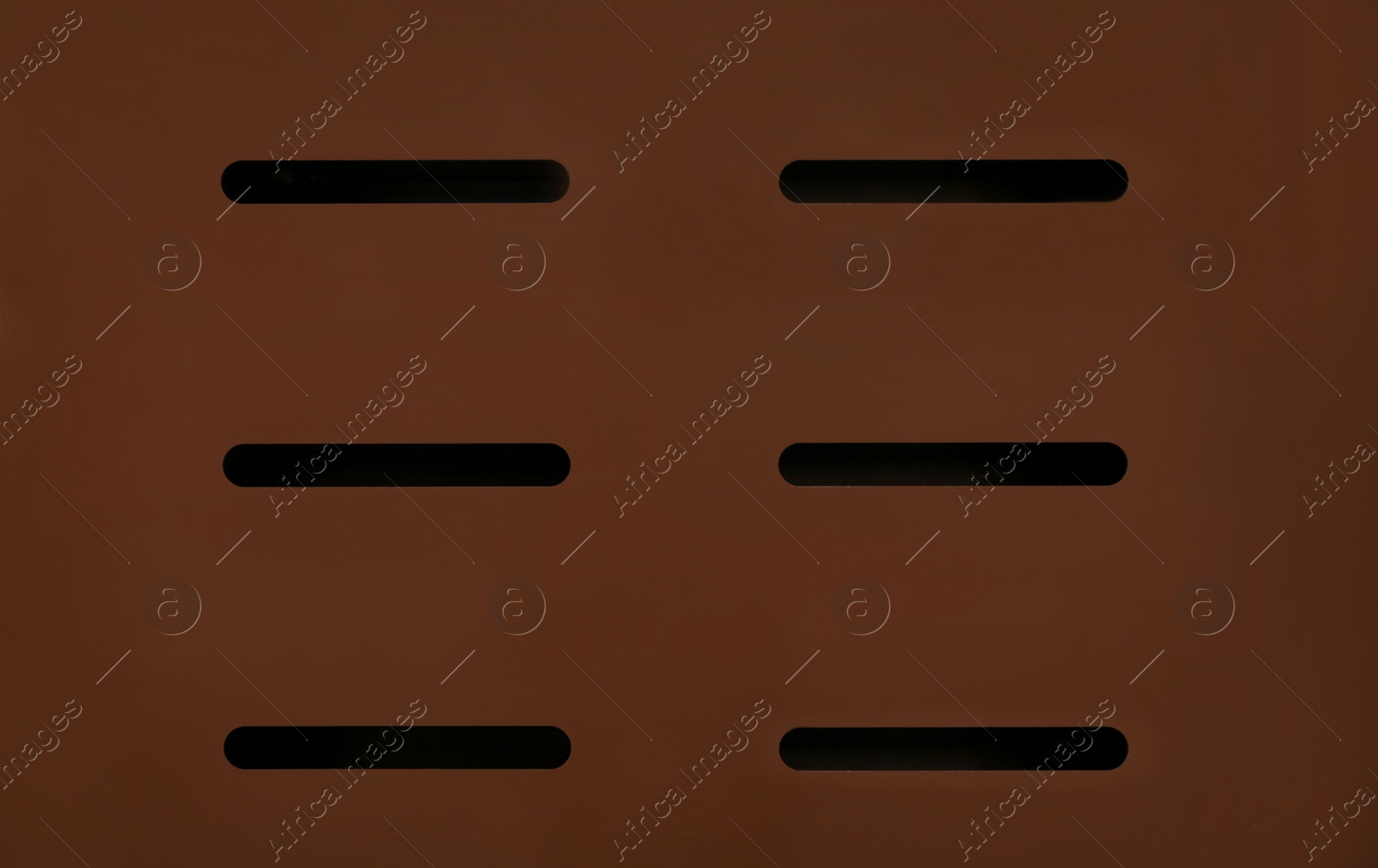 Photo of Brown open metal mail slot, closeup view