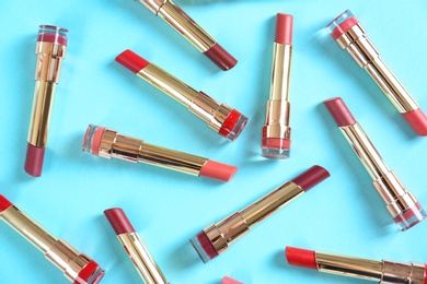 Photo of Flat lay composition with different stylish lipsticks on color background