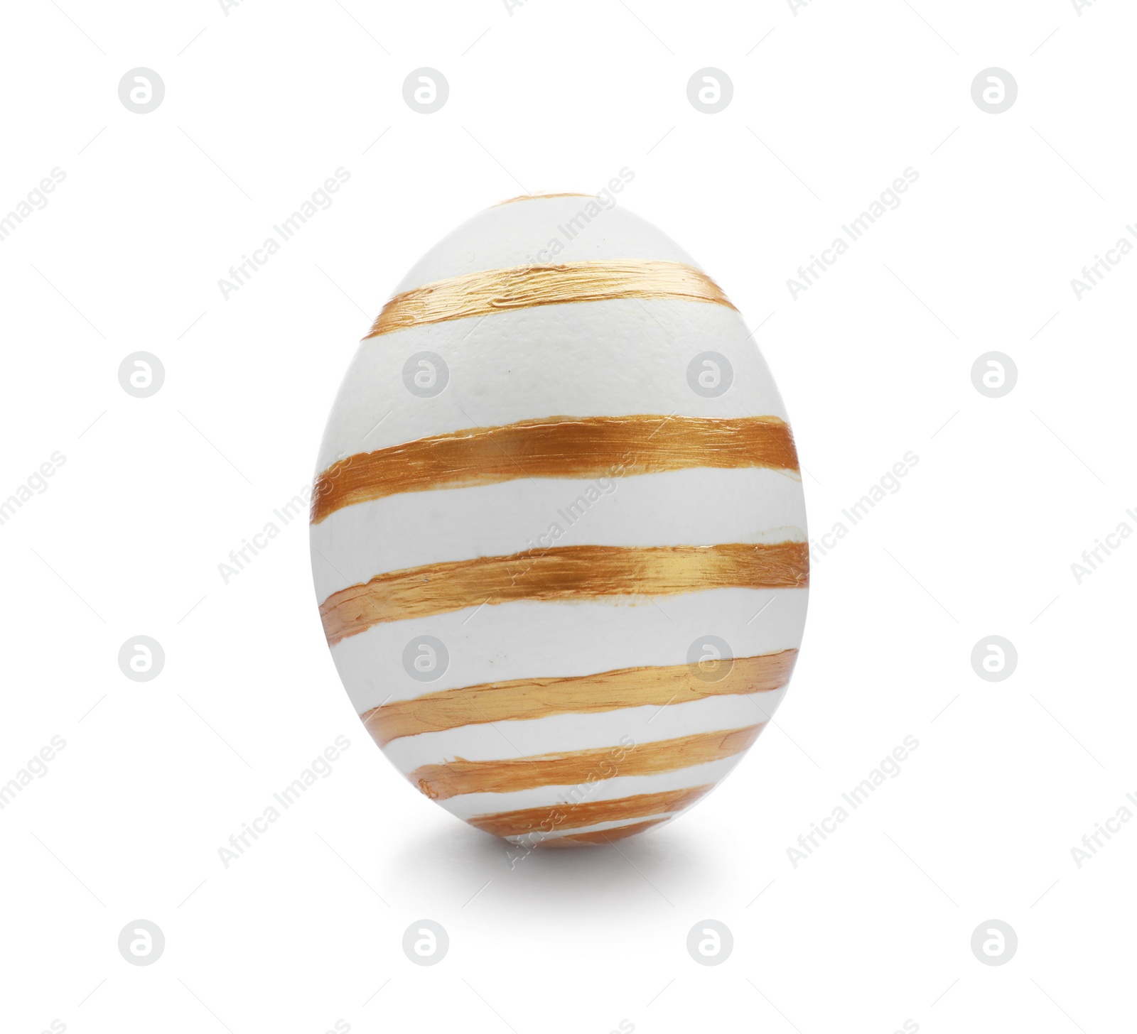 Photo of Traditional Easter egg decorated with golden paint on white background