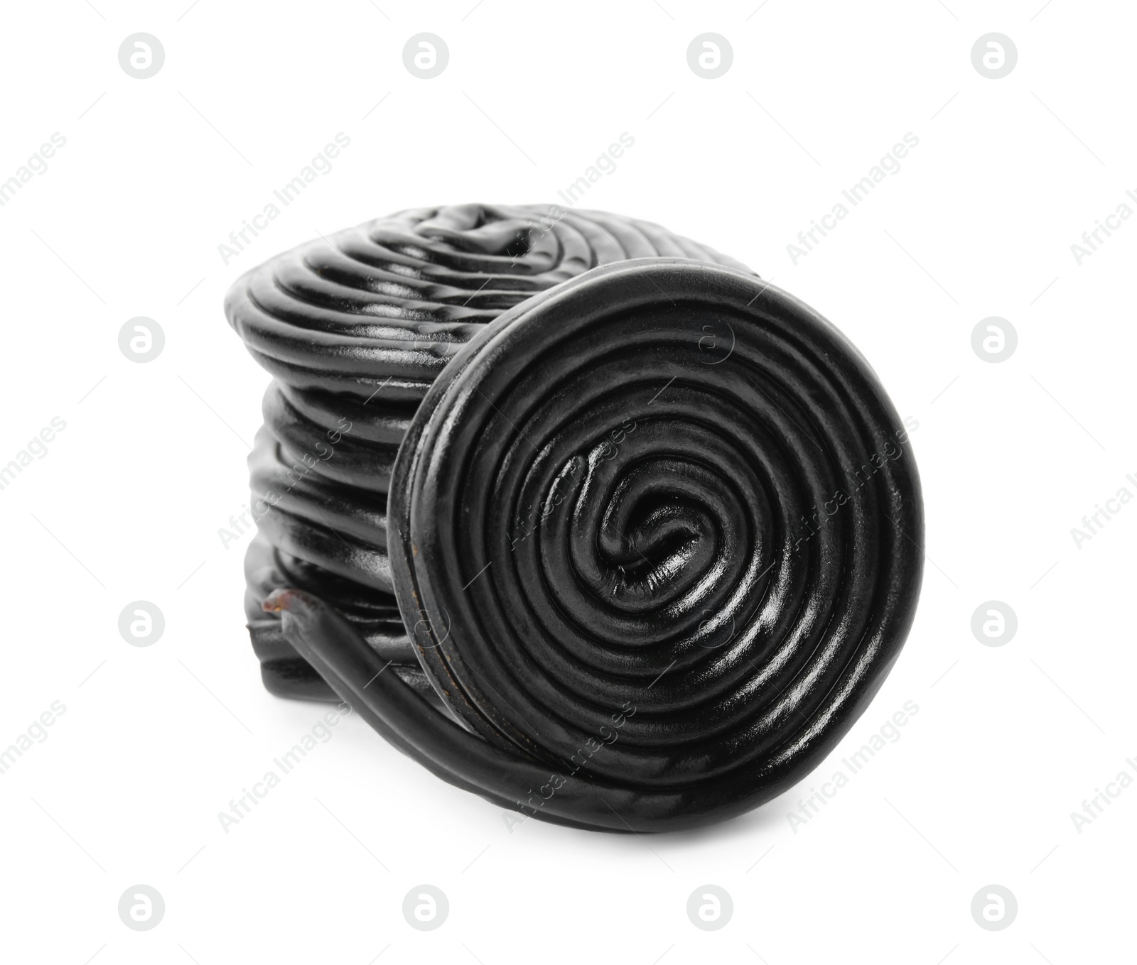 Photo of Tasty rolled liquorice candies on white background
