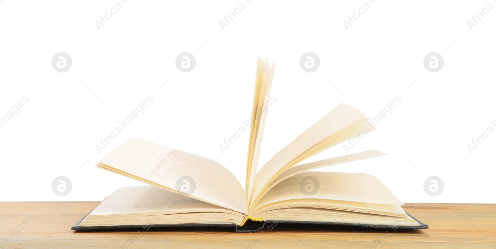 Photo of Open book on wooden table against white background