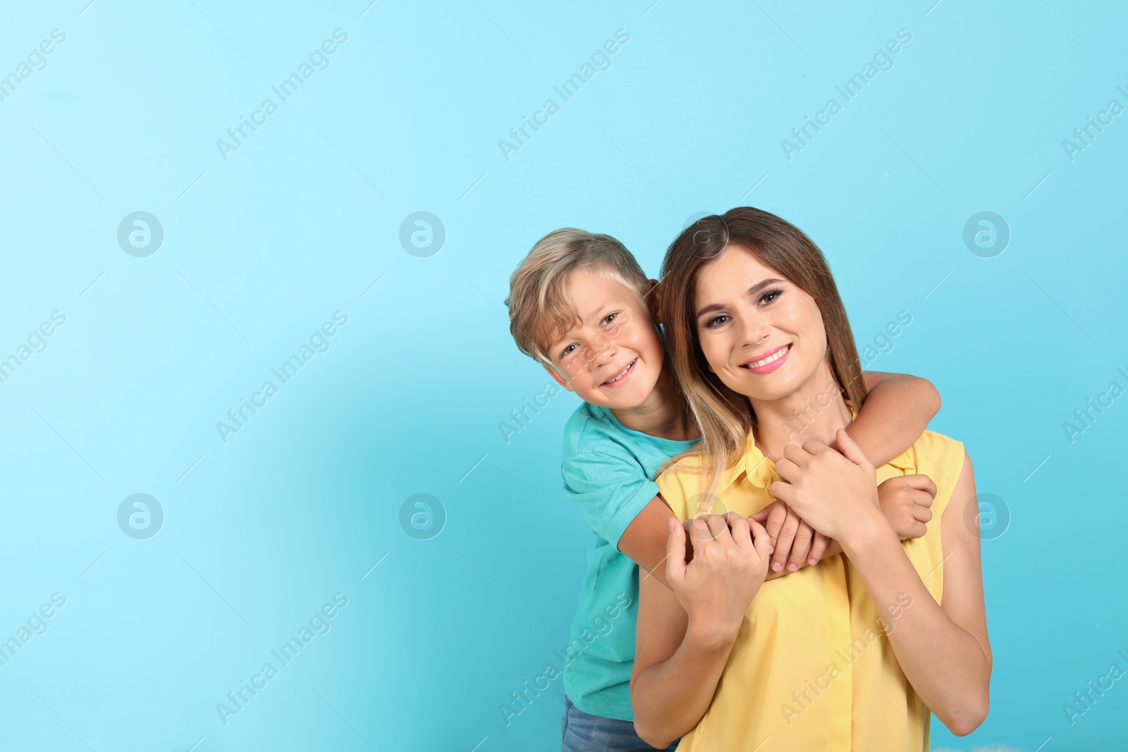 Photo of Portrait of mother and son on color background