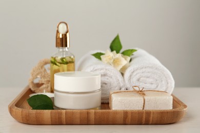 Photo of Composition with beautiful jasmine flowers and skin care products on white table