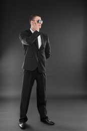 Male security guard in uniform on dark background