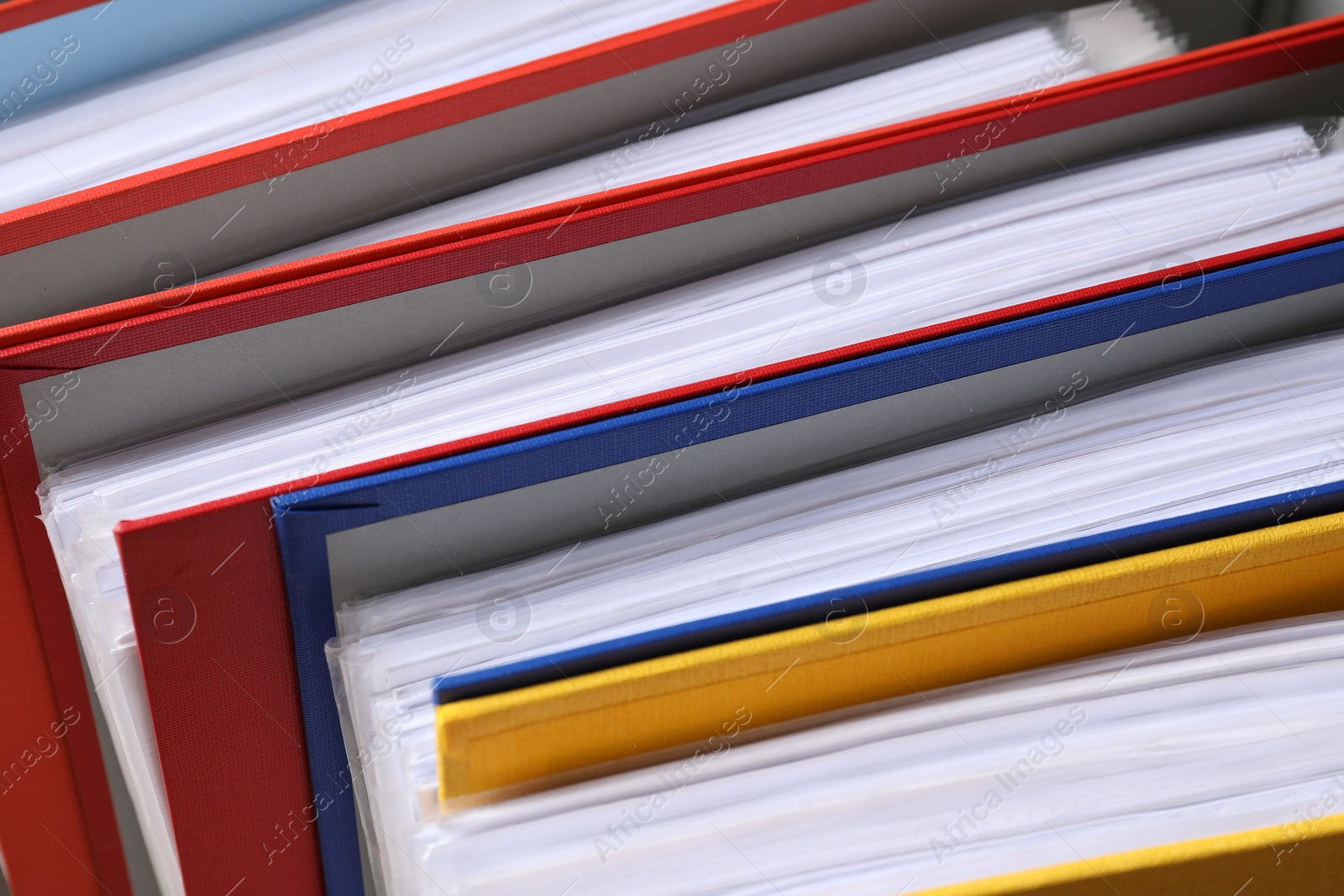 Photo of Colorful binder office folders as background, closeup