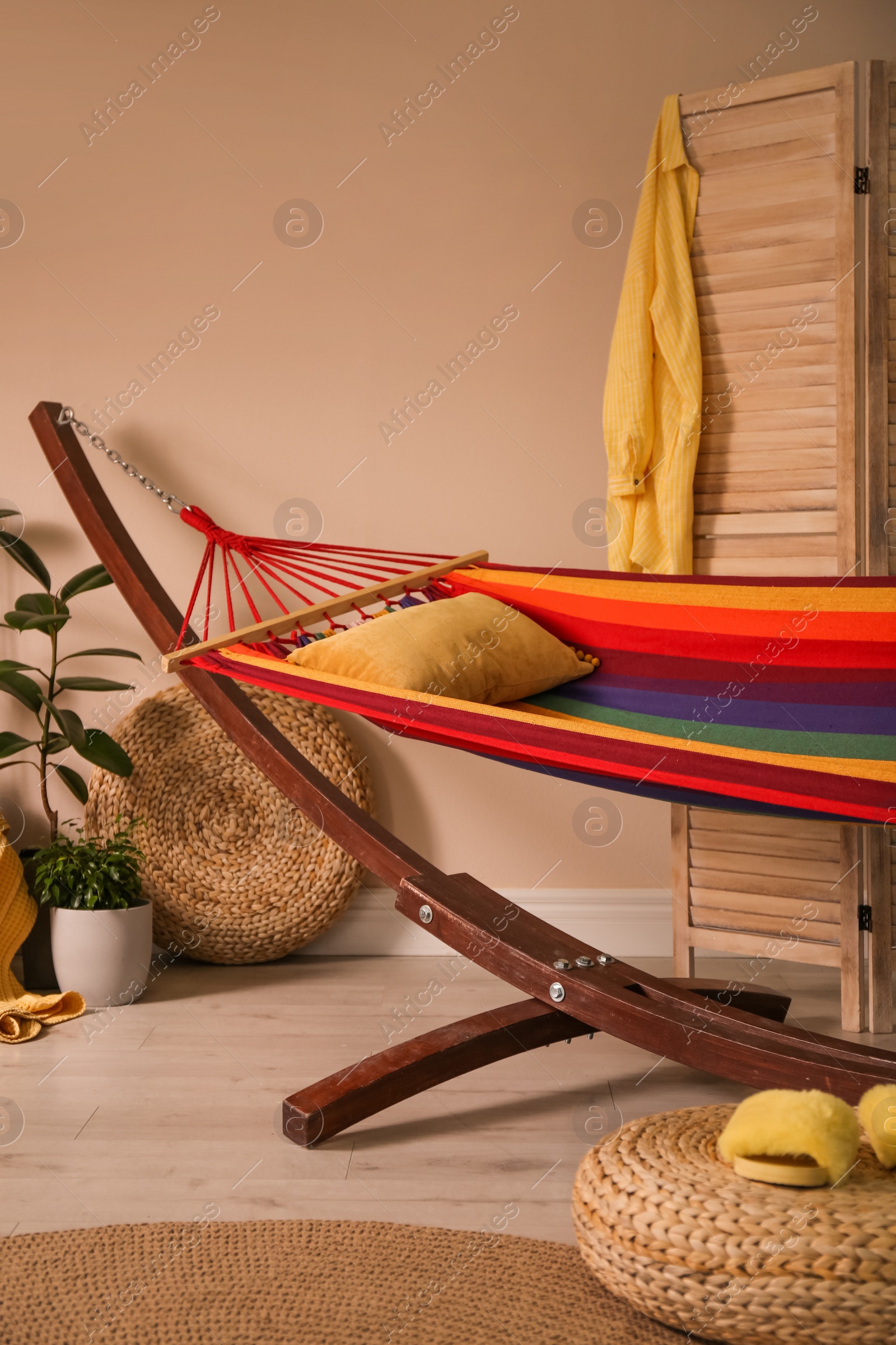 Photo of Colorful hammock with pillow in modern room interior