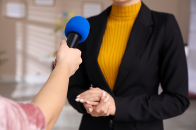 Photo of Professional journalist interviewing young woman in room, closeup