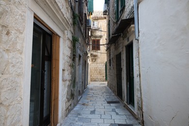 Empty street with passage between old buildings