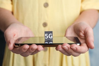 Photo of 5G technology, Internet concept. Woman holding smartphone with card, closeup