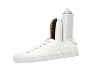 Photo of Stylish footwear with shoe care accessories on white background