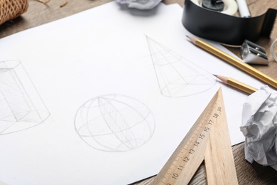 Photo of Drawing of geometry shapes on table, closeup. Designer's workplace