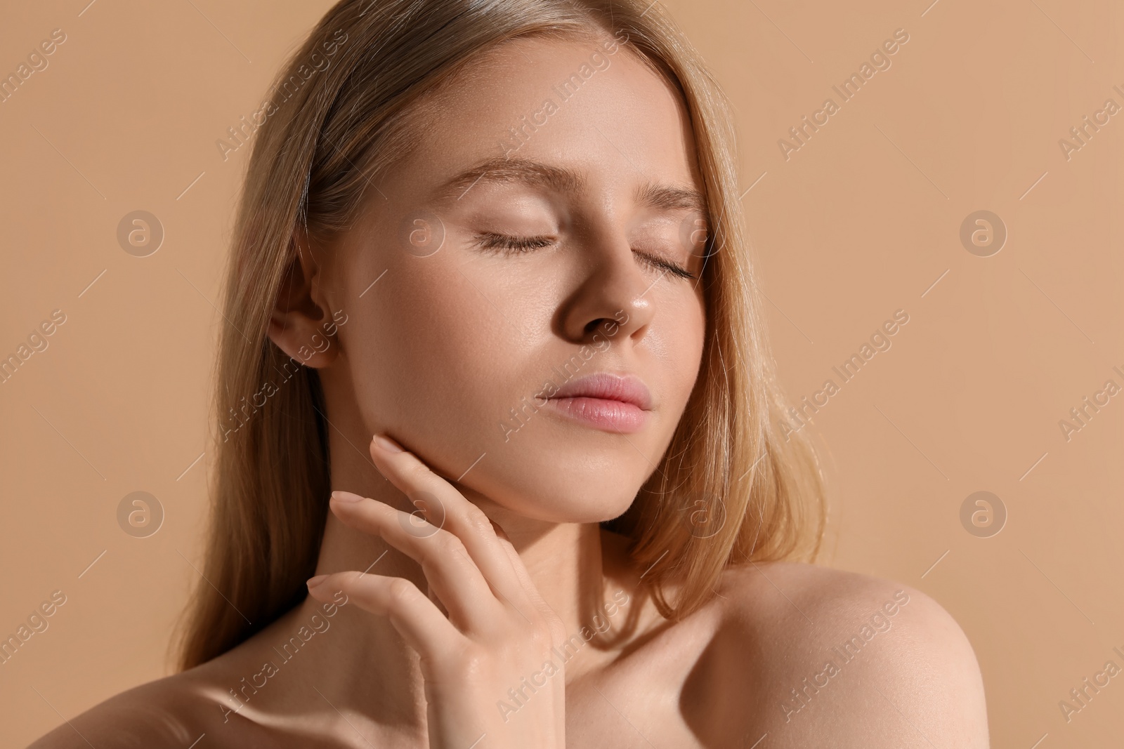 Photo of Beautiful young woman posing on beige background