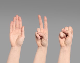 People playing rock, paper and scissors on grey background, closeup