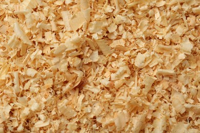 Photo of Dry natural sawdust as background, top view