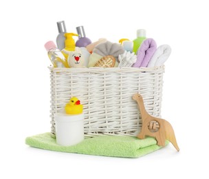 Wicker basket full of different baby cosmetic products, bathing accessories and toys on white background