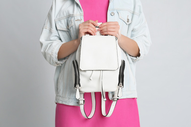 Photo of Young woman with stylish bag on grey background, closeup