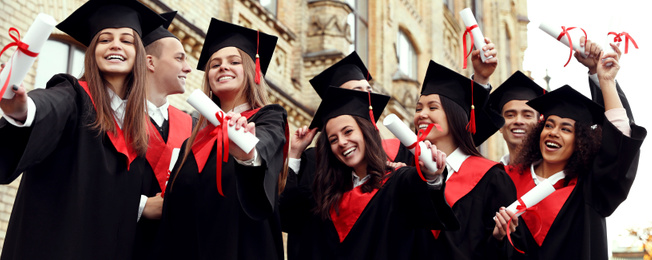 Image of Happy students with diplomas near campus. Banner design