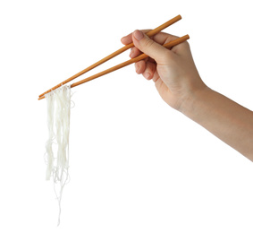 Photo of Woman holding chopsticks with tasty cooked rice noodles on white background, closeup