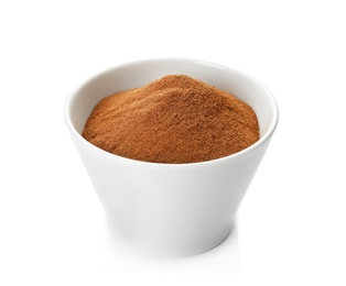 Photo of Bowl with aromatic cinnamon powder on white background