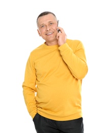 Portrait of mature man talking on phone against white background