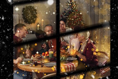 Happy family enjoying festive dinner at home, view through window. Christmas celebration