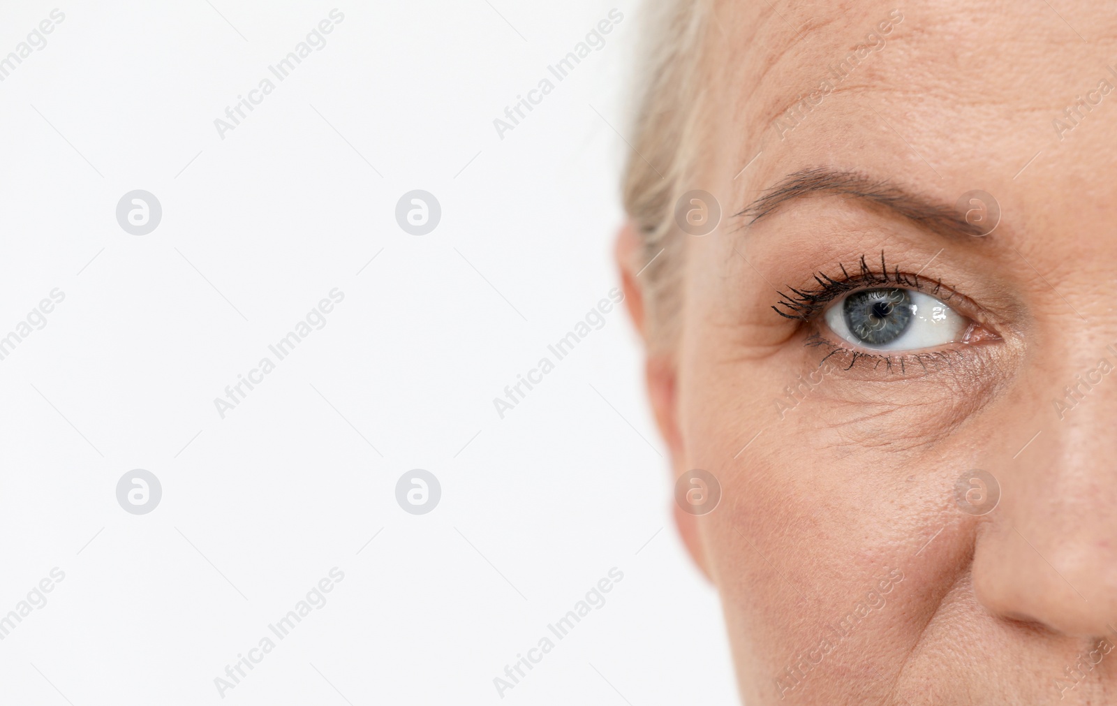 Photo of Closeup view of beautiful older woman on white background