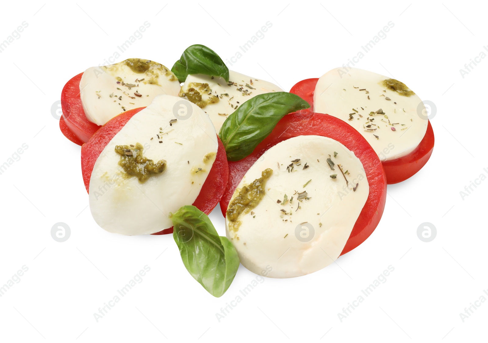 Photo of Tasty salad Caprese with mozzarella, tomatoes, basil and pesto sauce isolated on white