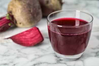 Photo of Glass with fresh healthy beet juice on table