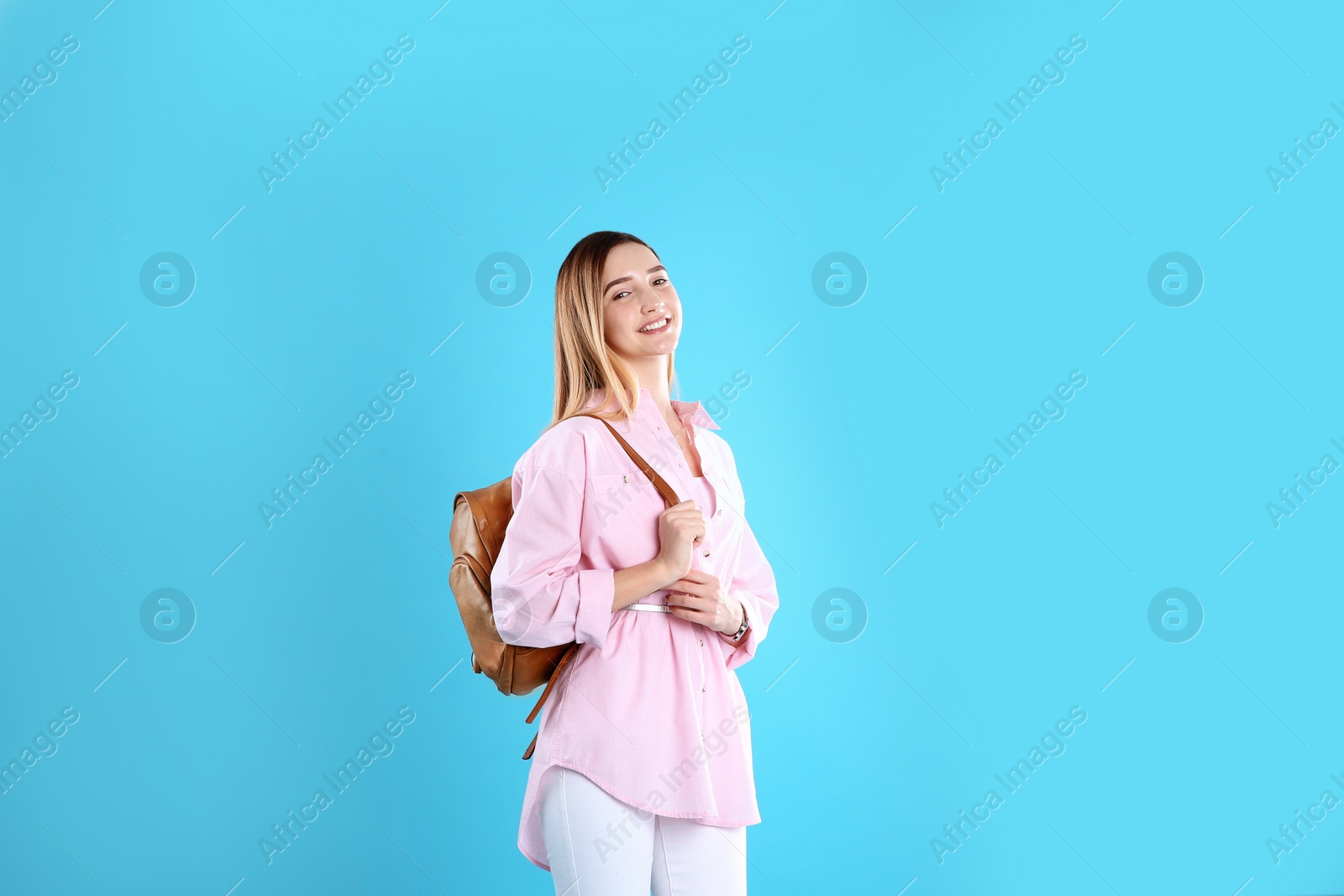 Photo of Teenage girl with backpack on color background