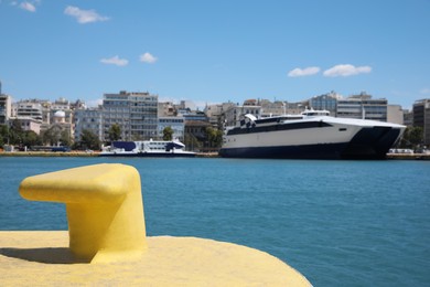 Yellow mooring hook in sea port on sunny day