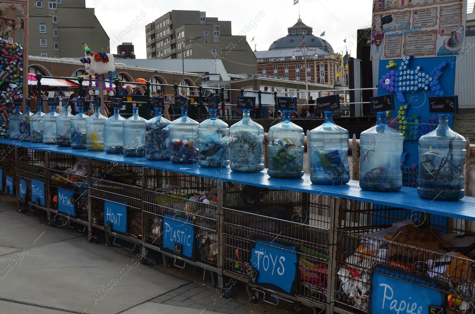 Photo of HAGUE, NETHERLANDS - SEPTEMBER 10, 2022: Many bottles as recycling containers outdoors on sunny day