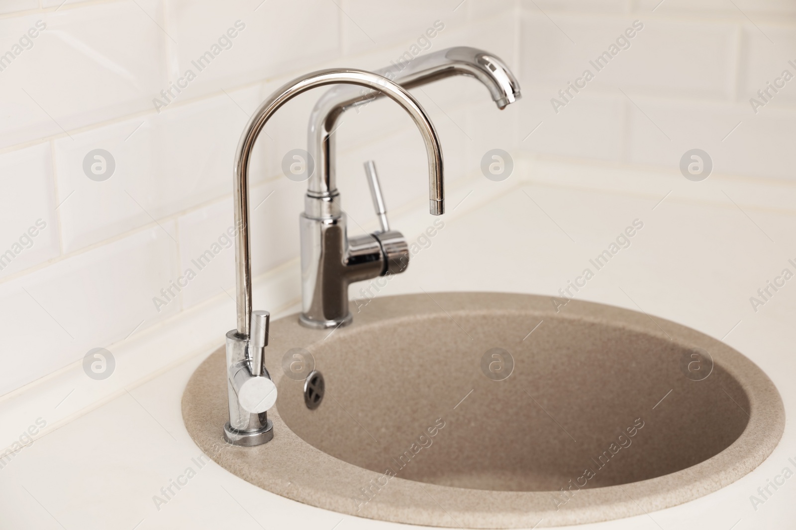 Photo of Empty kitchen sink with faucets. Idea for interior design